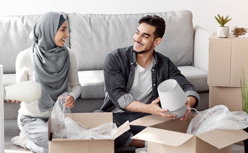Relocation Service Man and Woman Discussing while opening the packages